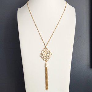 Gold scroll design pendant necklace with tassel